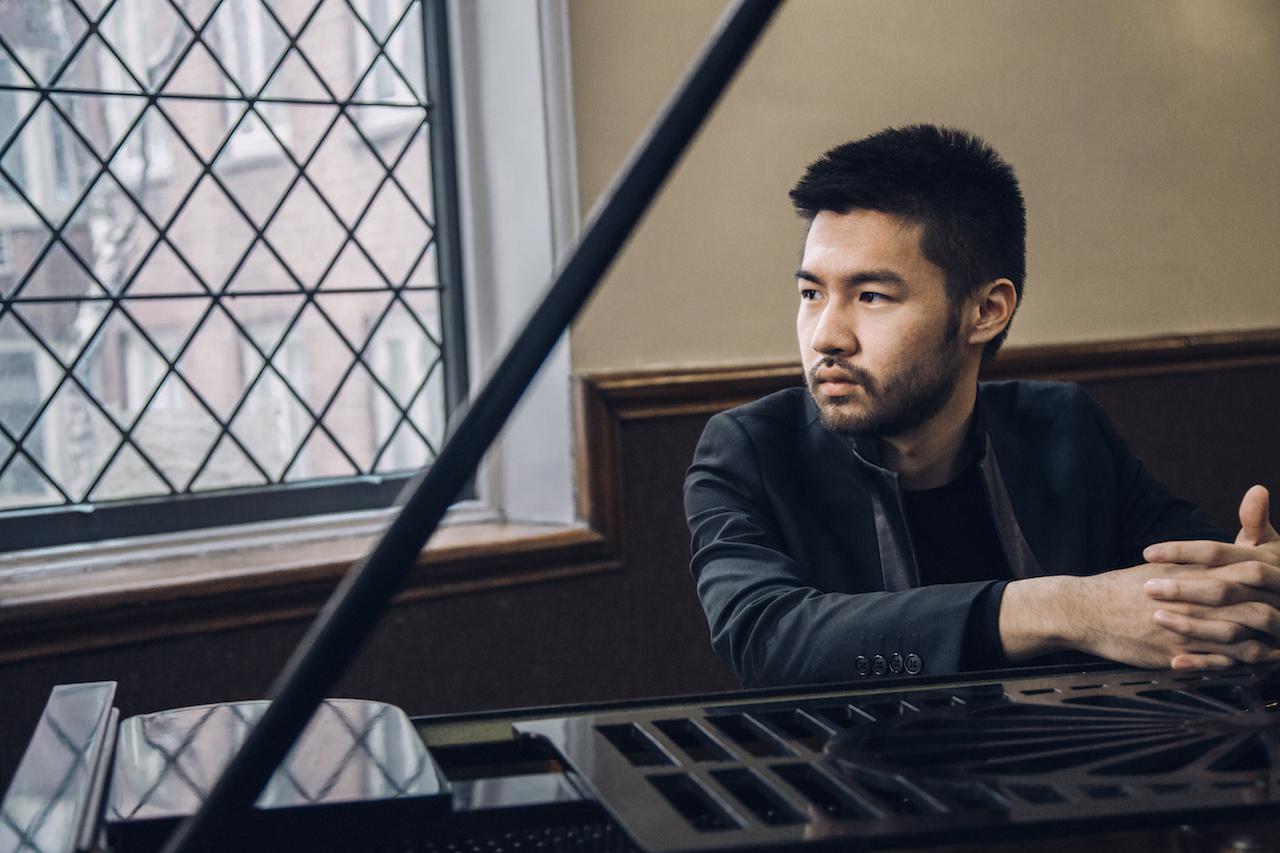 Promotional image of Conrad Tao at the piano