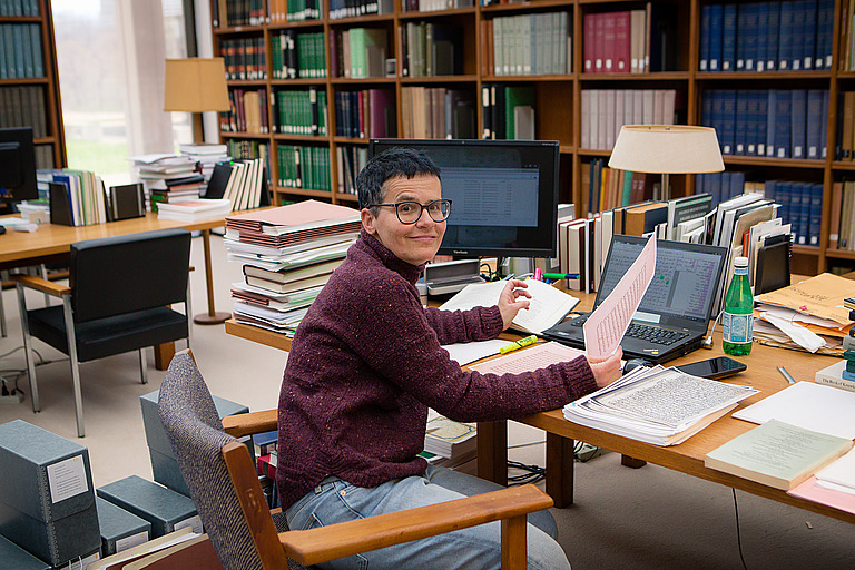 Sabine Schmidtke poses for a photo in the library