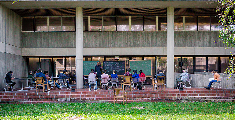 Edward Witten lectures to a socially distanced audience outside the birch gardens at IAS