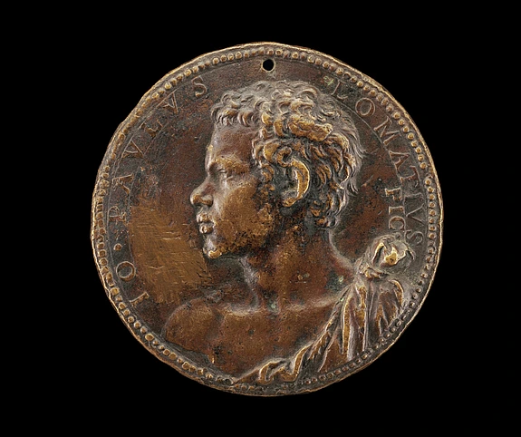 Bronze portrait medal showing a man with curly hair in profile, facing left, in high relief detail with engraved text round the edge