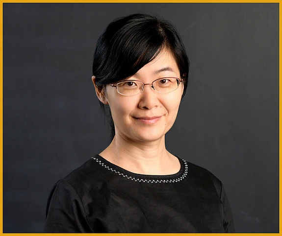 Yingyao Wang headshot against a blank blackboard