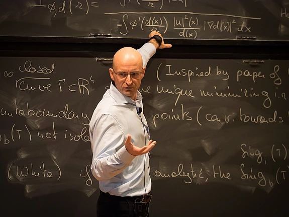 Camillo De Lellis speaks at the blackboard