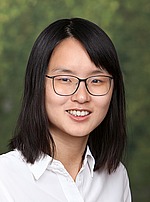 Headshot of Danqi Chen.  She is smiling, wearing a white, button-down shirt, and sitting in front of a green backdrop.