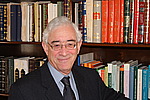 Etan Kohlberg in front of bookcase