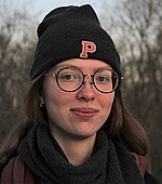 A headshot of Ekaterina Ivshina.  She is wearing a black scarf, black Princeton University winter hat, and standing outside.
