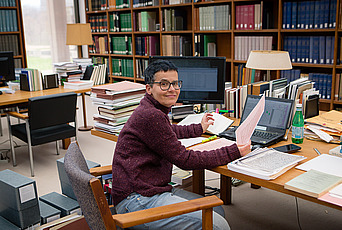 Sabine Schmidtke poses for a photo in the library