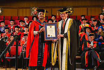 Akshay Venkatesh accepts an honorary doctorate during a ceremony at the University of Western Australia