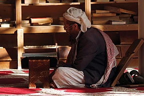A Yemeni man reads the Qur'an at the Great Mosque in the old city of the capital Sana’a.