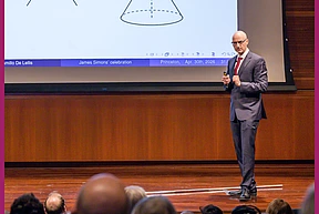 De Lellis giving a lecture on stage in Wolfensohn Hall