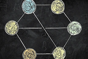 Blackboard drawing of hexagonal figure with circular vertices and bisecting X