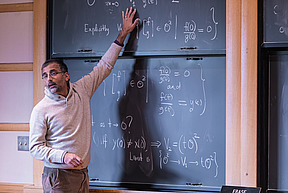 Akshay Venkatesh answers a question at the blackboard