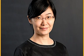 Yingyao Wang headshot against a blank blackboard