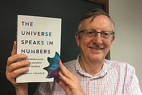 Graham Farmelo poses with his book "The Universe Speaks in Numbers"