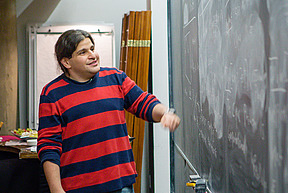 Dor Minzer speaks in front of the blackboard in the Dilworth Room at the IAS