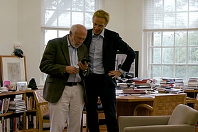 Jim Simons stands reading with Robbert Dijkgraaf