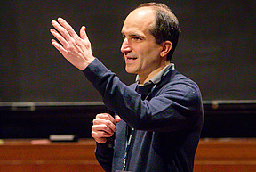 Juan Maldacena speaks on stage in Wolfensohn Hall