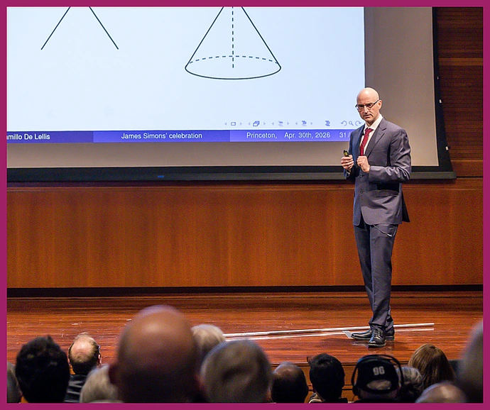 De Lellis giving a lecture on stage in Wolfensohn Hall