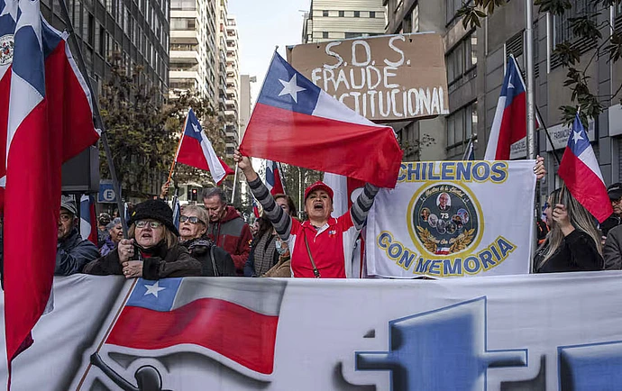 Demonstrators protest against the constitutional process during a meeting of the Constitutional Convention outside the former Chilean National Congress in Santiago, Chile, on Wednesday, June 7, 2023.