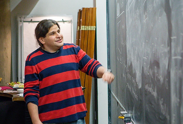 Dor Minzer speaks in front of the blackboard in the Dilworth Room at the IAS