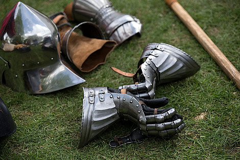 Medieval armor is strewn across the ground