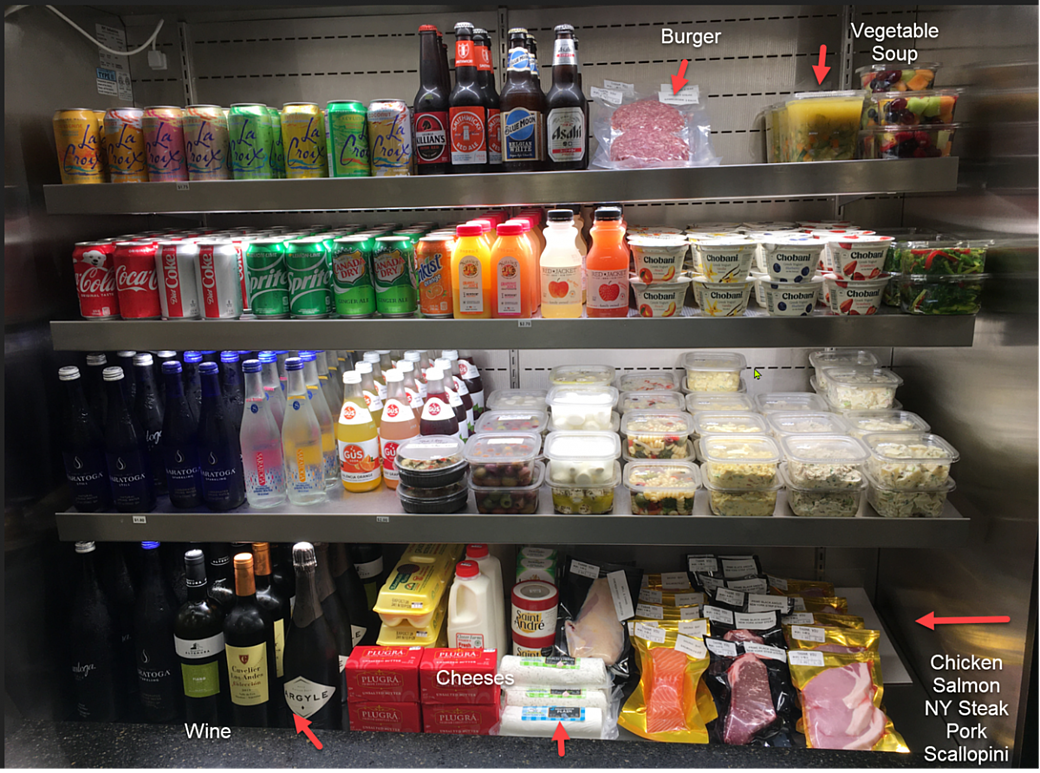 Beverage case with beverages, cheese, and meats.