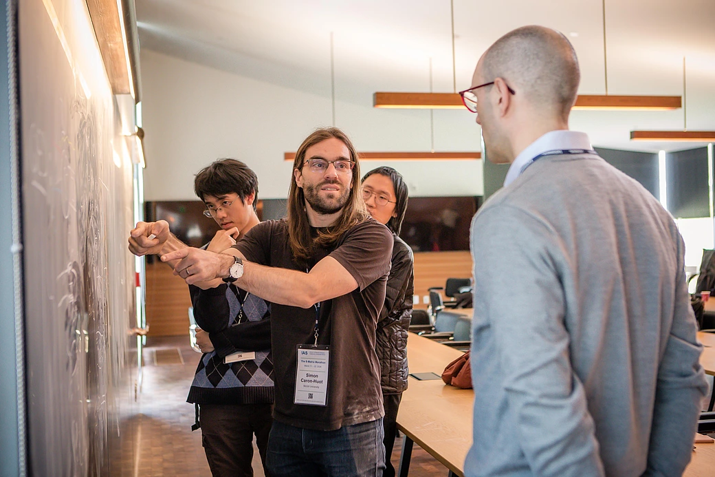 Simon Caron-Huot explains his research to Enrico Pajer