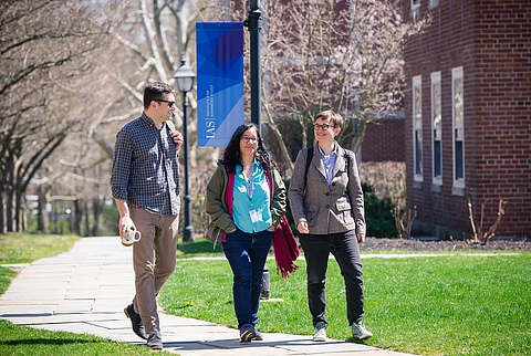 Social Science scholars walking past Bloomberg Hall